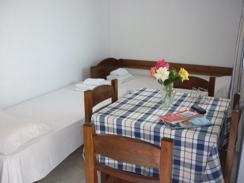 a table with a vase of flowers on it at Joanna Apartments in Mikri Vigla