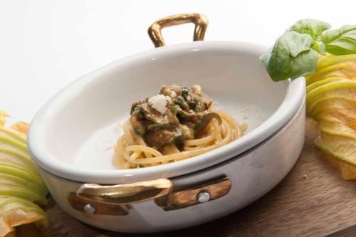 a bowl of pasta with meat and cheese on a table at Taverna Del Capitano in Massa Lubrense