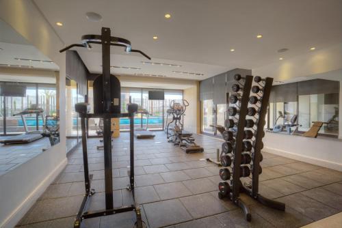 a gym with treadmills and exercise equipment in a building at The House Boutique Suites in Amman
