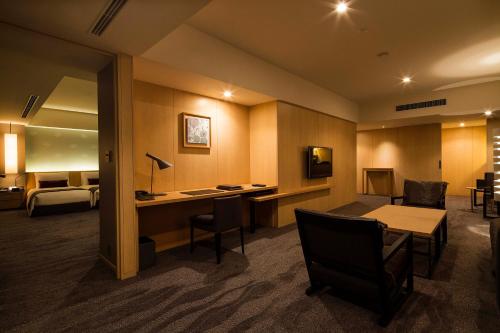 a hotel room with a desk and a bed at The Capitol Hotel Tokyu in Tokyo