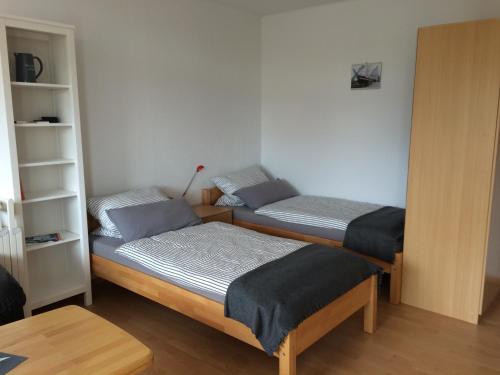 - une chambre avec 2 lits et une étagère dans l'établissement Ferienwohnung "Krabbe", à Bremerhaven