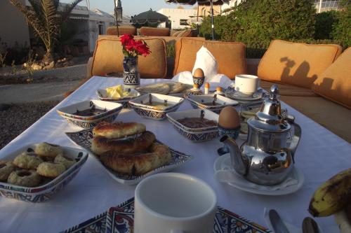 a table with pastries and food on top at Aftas Trip in Mirleft