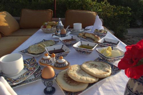 a table with eggs and food on a table at Aftas Trip in Mirleft