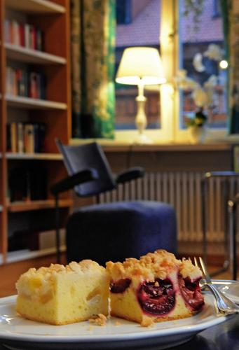a piece of cake on a plate with a fork at Ferien Residenz Bergfried in Hinterzarten