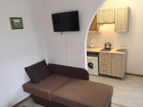 a living room with a couch and a kitchen at Polyana Apart in Polyana