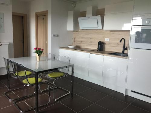 a kitchen with a table and chairs and a refrigerator at Monte Paradiso Panorama in Pula
