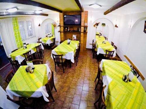 an overhead view of a restaurant with yellow tables and chairs at Penzion U Králíků in Kurdějov