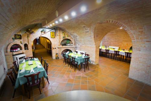 a dining room with tables and chairs in a building at Penzion U Králíků in Kurdějov