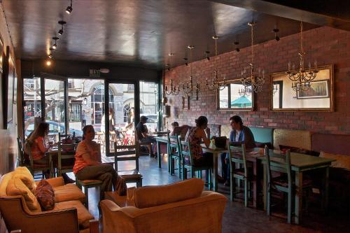 a room with people sitting at tables in a restaurant at Hotel Villa Marina in Ensenada