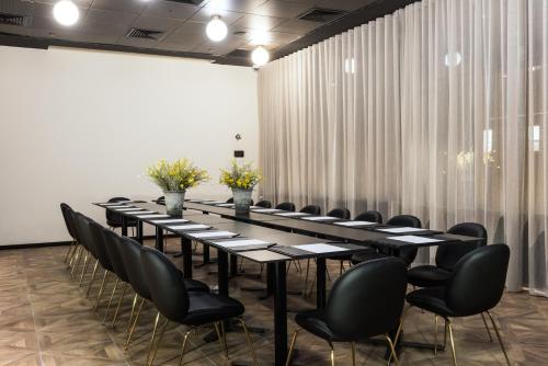 a conference room with a long table and black chairs at Leonardo Boutique Jerusalem in Jerusalem