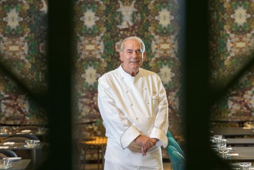 a man in a chef outfit standing in a restaurant at Leonardo Boutique Jerusalem in Jerusalem
