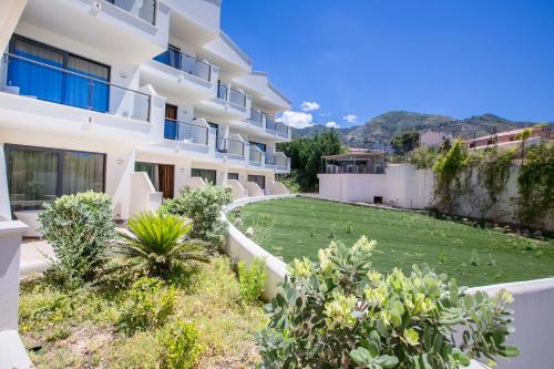 an external view of a building with a yard at Cefalù Sea Palace in Cefalù
