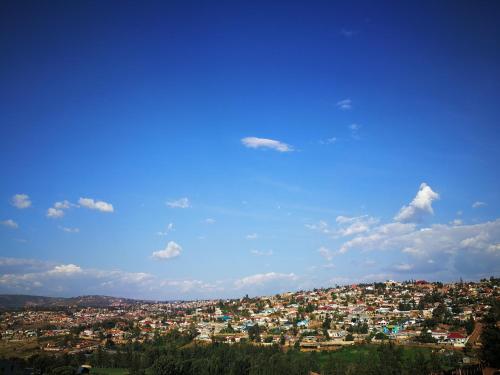 a city on a hill with a blue sky at Dmall Hotel in Kigali