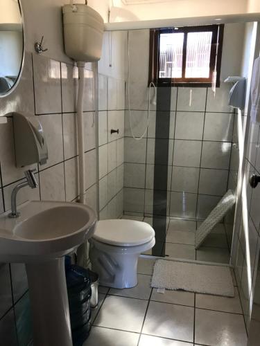 a small bathroom with a toilet and a sink at Chalés Energias da Serra in Bom Jardim da Serra