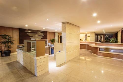 a large kitchen with a island in a house at Crown Victoria Hotel Tulungagung in Tulungagung