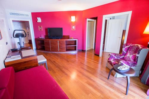 a living room with red walls and a red couch at Cefalù Sea Palace in Cefalù