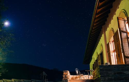 a building at night with the moon in the sky at Casa Kraus in Criţ