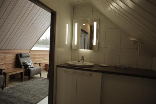 a bathroom with a sink and a mirror at Levi Northern Lights Huts in Levi