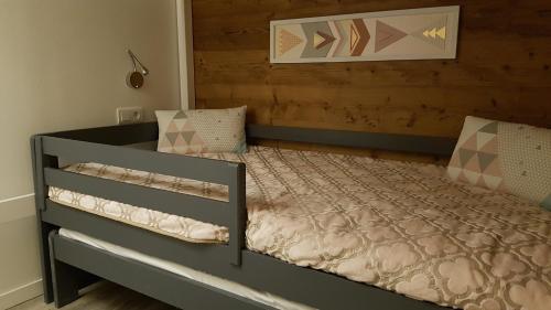 a bedroom with a bed with a wooden headboard at Carene - Belle plagne - 8 personnes in Belle Plagne