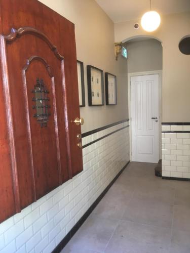 an empty room with a wooden door and a hallway at ExLibris Boutique Hotel in Leiden