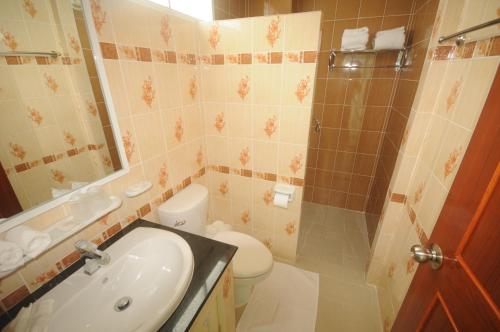 a bathroom with a sink and a toilet and a shower at Chinathip Yusabuy in Nan