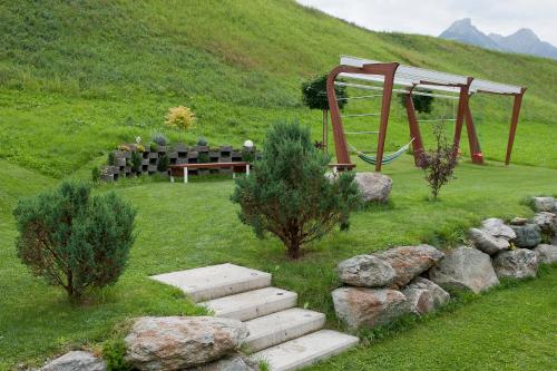 a park with a playground and a bench and a swing at Ferienwohnung Robi in Fulpmes