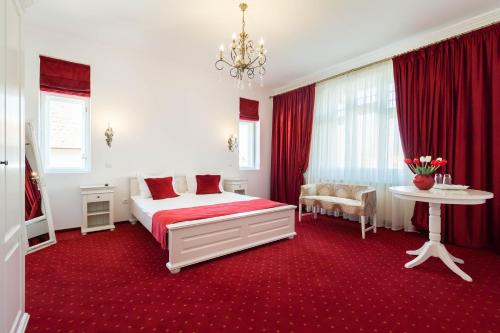 1 dormitorio con 1 cama y alfombra roja en Vila Mărioara, en Sibiu