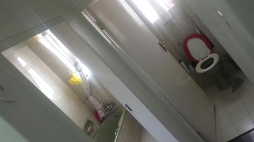 a small bathroom with a toilet and a sink at Rosebank Accommodation in Johannesburg