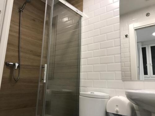 a bathroom with a shower and a toilet and a sink at Winederful Hostel & Café in Logroño