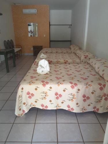 a bed with a stuffed animal sitting on top of it at Balcon Gueela in Santa Cruz Huatulco