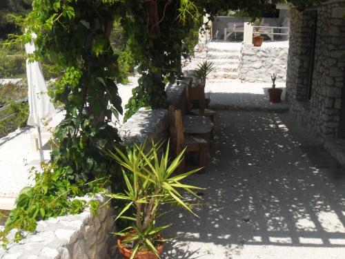 a courtyard with some plants and a stone wall at Holiday Home Villa Venta in Trogir