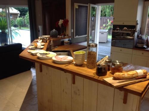 a kitchen with a wooden counter with food on it at Les Rives du Bassin in Le Teich