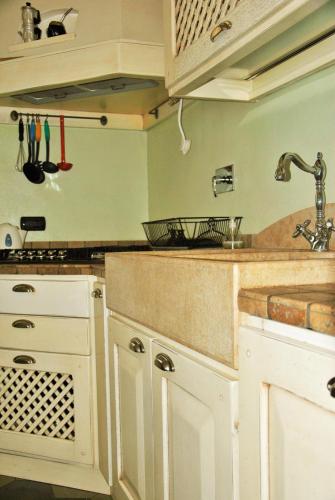 a kitchen with white cabinets and a sink at Casa Rattazzi in Turin