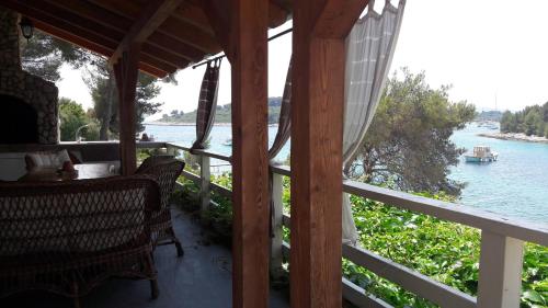 a porch with a view of the water at Holiday Home Villa Venta in Trogir