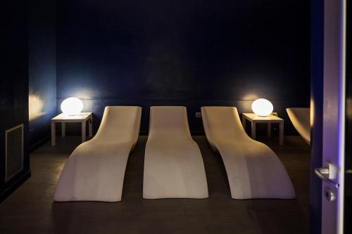 a row of white chairs with lights on them at Grifo Hotel Charme & SPA in Ischia