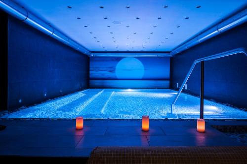 a large swimming pool in a blue room with lights at Grifo Hotel Charme & SPA in Ischia