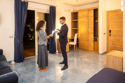 a man and a woman standing in a room at Grifo Hotel Charme & SPA in Ischia