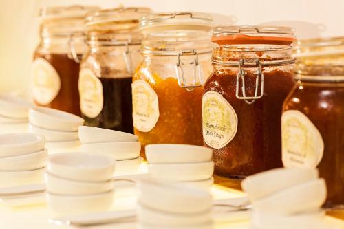 a group of jars of honey on a table at Grifo Hotel Charme & SPA in Ischia