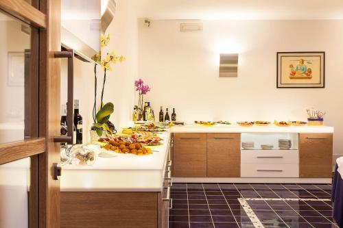 a kitchen with a counter with fruit on it at Grifo Hotel Charme & SPA in Ischia