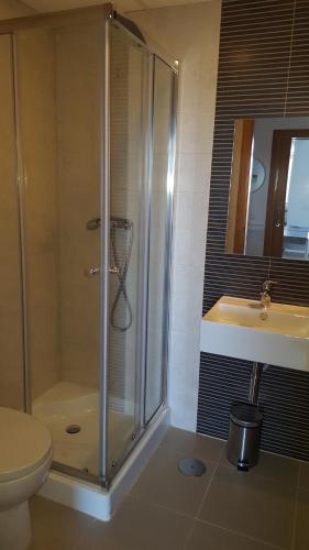 a bathroom with a shower and a toilet and a sink at Nautico Entremares in La Manga del Mar Menor
