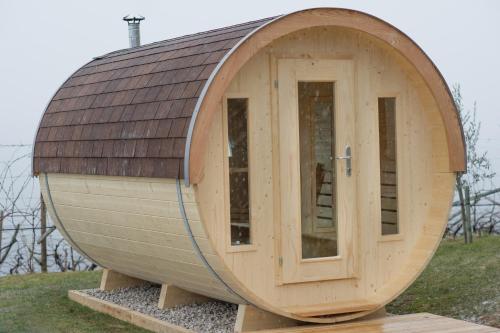 a circular house with a roof on top of it at Biobauernhof St. Quirinus in Caldaro