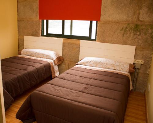 A bed or beds in a room at Hospedaje Bahía de San Simon