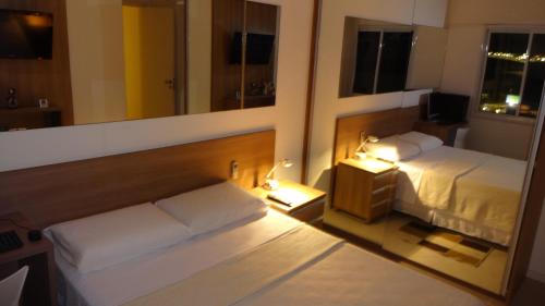 Кровать или кровати в номере Apart no Cond JTR - Maceió