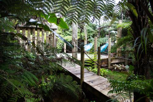 a playground with a slide in a garden at Hush Boutique Accommodation in Coromandel Town