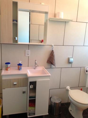 a bathroom with a sink and a toilet at bei Mot - Apartamento de Férias in Pomerode