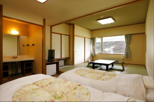 Postel nebo postele na pokoji v ubytování Manza Juraku All-inclusive Hotel