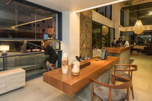 a man standing at a counter in a restaurant at Jinhold Hotel & Serviced Apartment in Miri