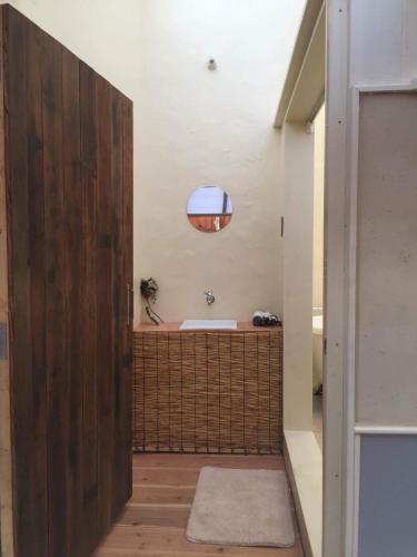 a bathroom with a tub and a sink at Kyoto style small inn Iru in Kyoto