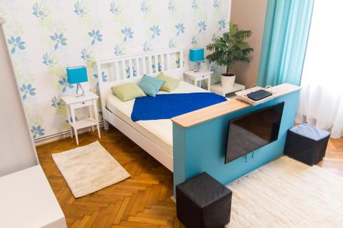 een slaapkamer met een bed en een tv. bij Chic and Very Central in Boedapest
