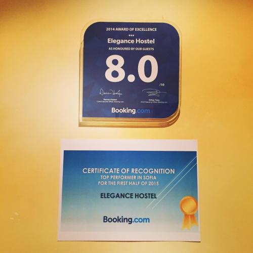 a sign hanging on a wall with a certificate of recognition at Elegance on a Budget - Rooms for Rent in Sofia Center in Sofia